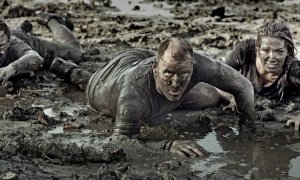 group of friends crawling in mud